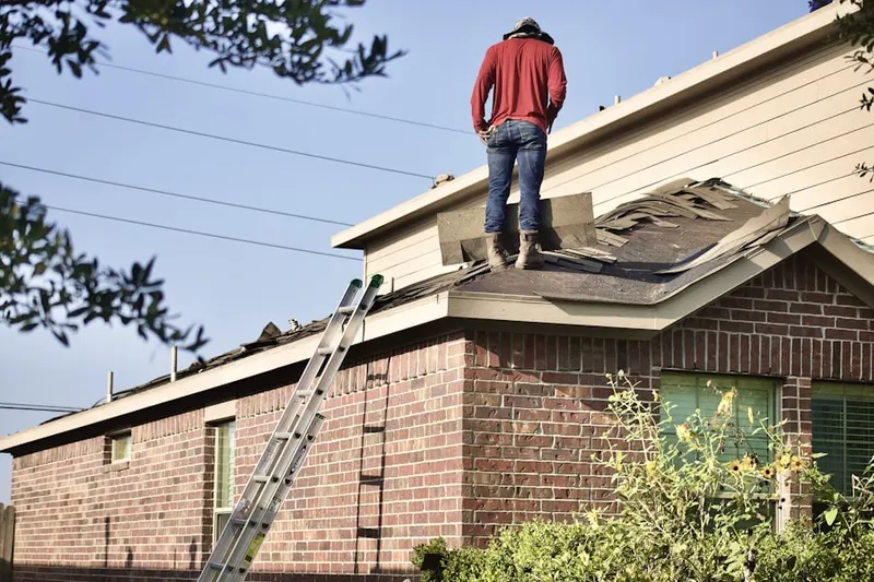 Professional roofer working on a residential roof in Rockingham